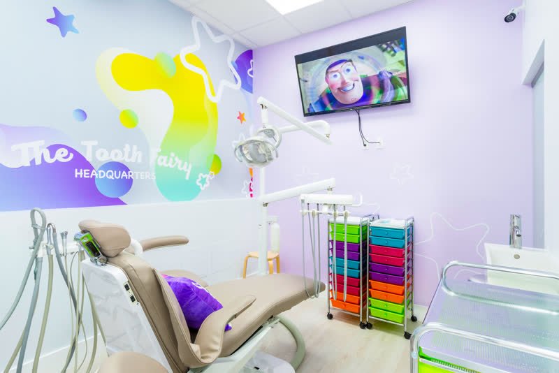 Colorful pediatric dental treatment room with a TV at The Tooth Fairy HQ in North Lauderdale, FL